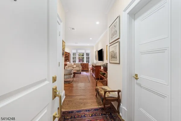 a hallway with white appliances and cabinets
