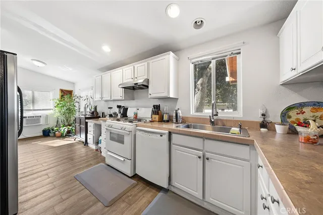a kitchen with a sink cabinets and window
