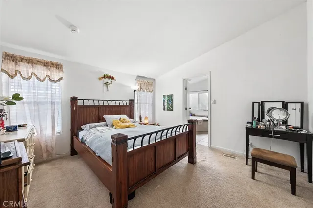 a bedroom with a bed and a table in it