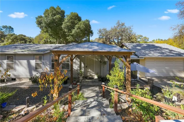 a view of a patio with table and chairs and potted plants