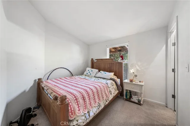 a bedroom with a bed and a lamp