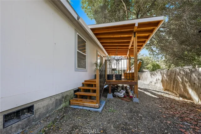 a backyard of a house with table and chairs