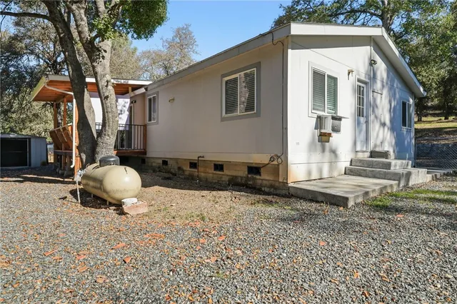 a backyard of a house with barbeque oven