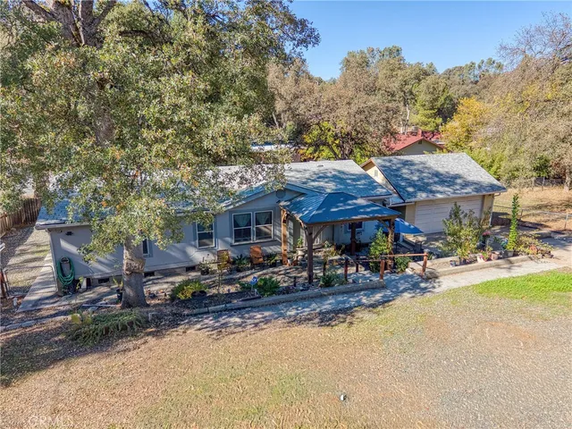 a view of the house with backyard and sitting area