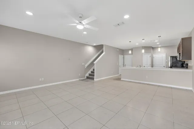 a view of an empty room with a ceiling fan