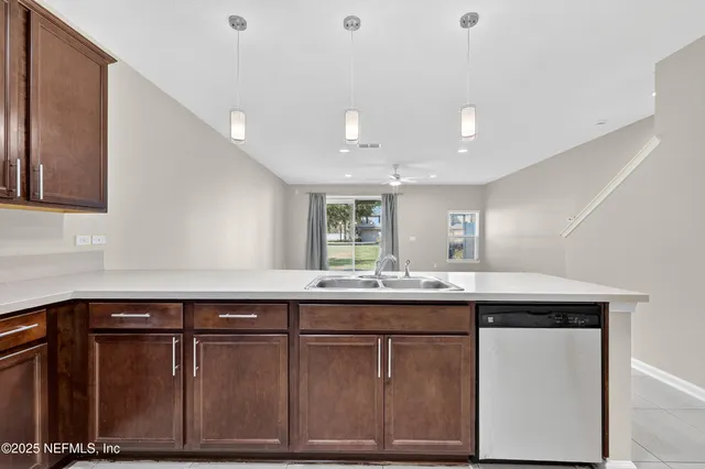 a view of kitchen with stainless steel appliances granite countertop sink