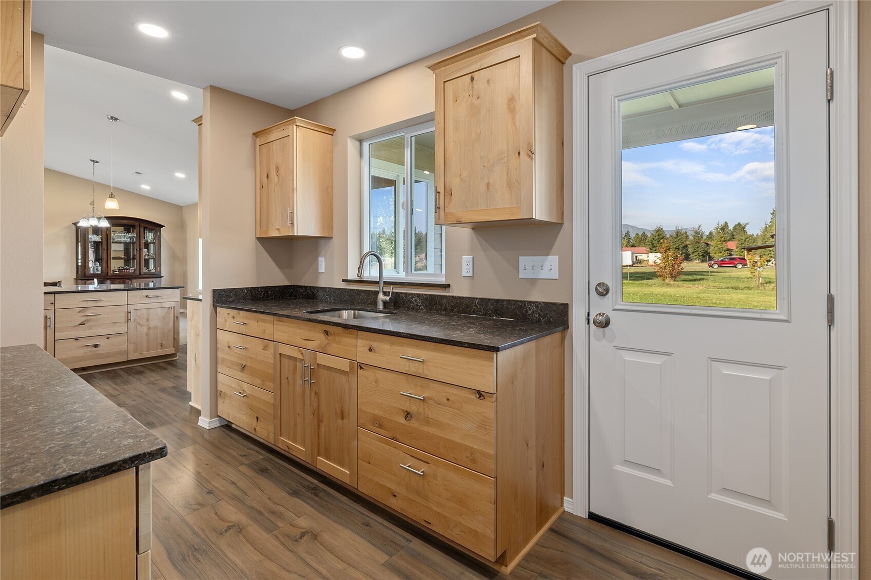 491 Pease Road Cle Elum, WA 98922 - Photo 13 of 38 a kitchen with stainless steel appliances granite countertop a sink and a stove with wooden floor