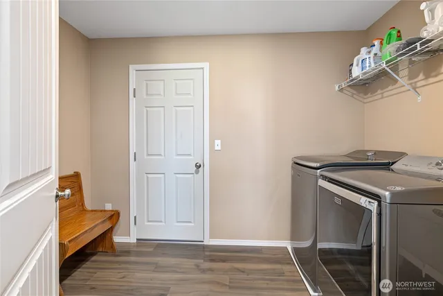 a view of a livingroom with wooden floor and furniture
