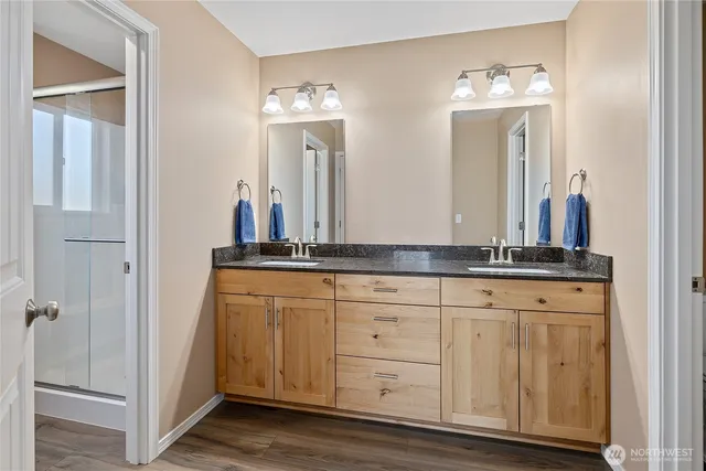 a bathroom with a double vanity sink and a mirror