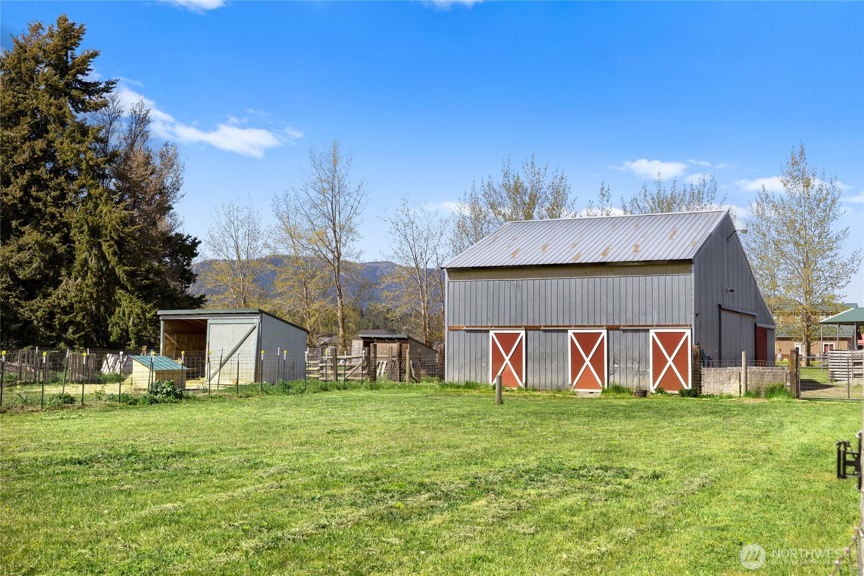 491 Pease Road Cle Elum, WA 98922 - Photo 34 of 38 a view of a white house with a big yard and large trees