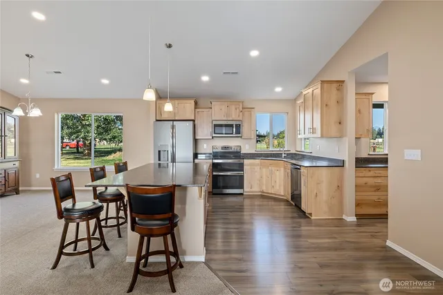 a kitchen with a sink cabinets and wooden floor