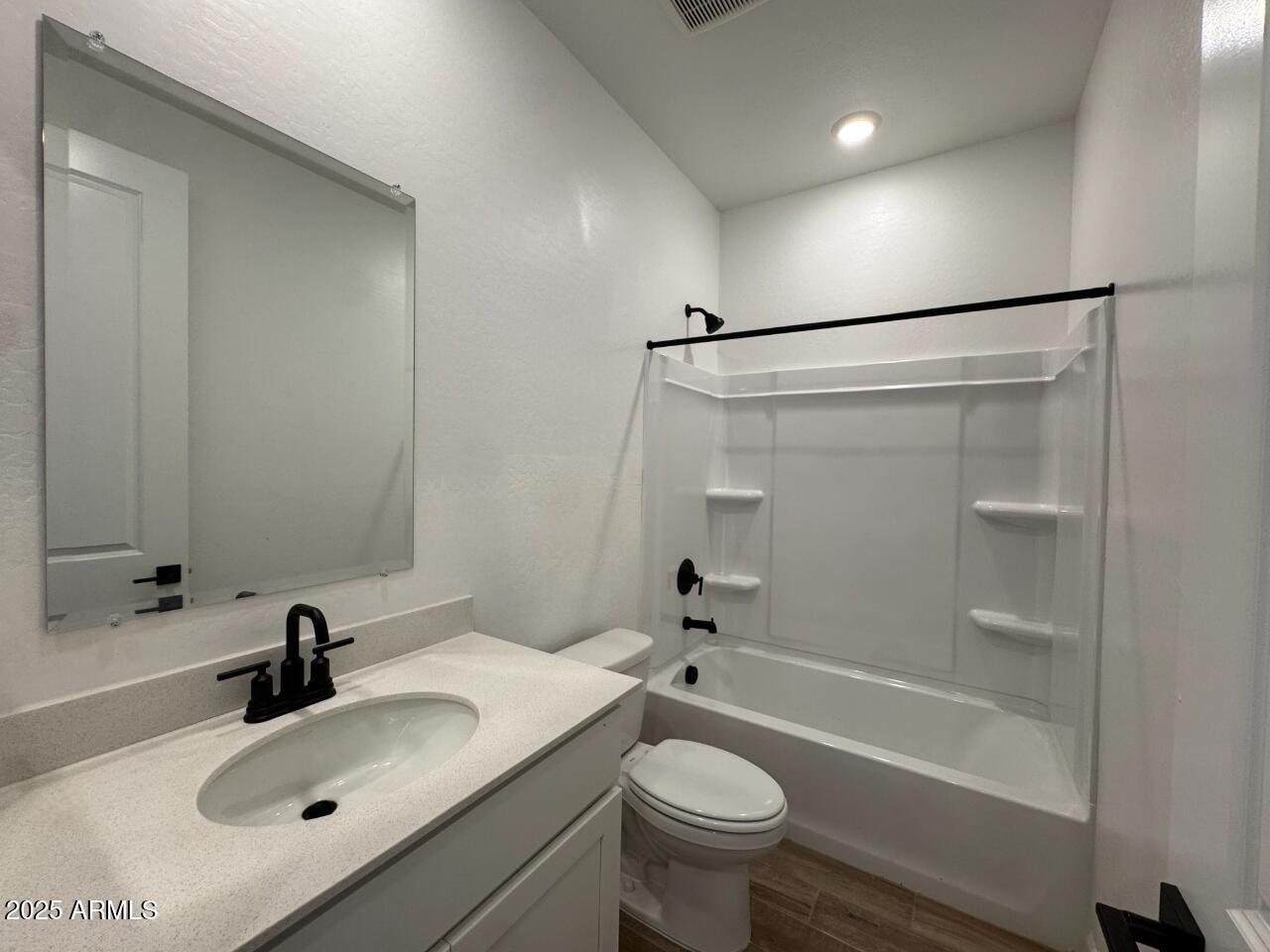 16181 West Bajada Road Surprise, AZ 85387 - Photo 4 of 21 a bathroom with a sink mirror toilet and bathtub