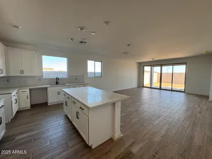 a kitchen with wooden floors and white walls