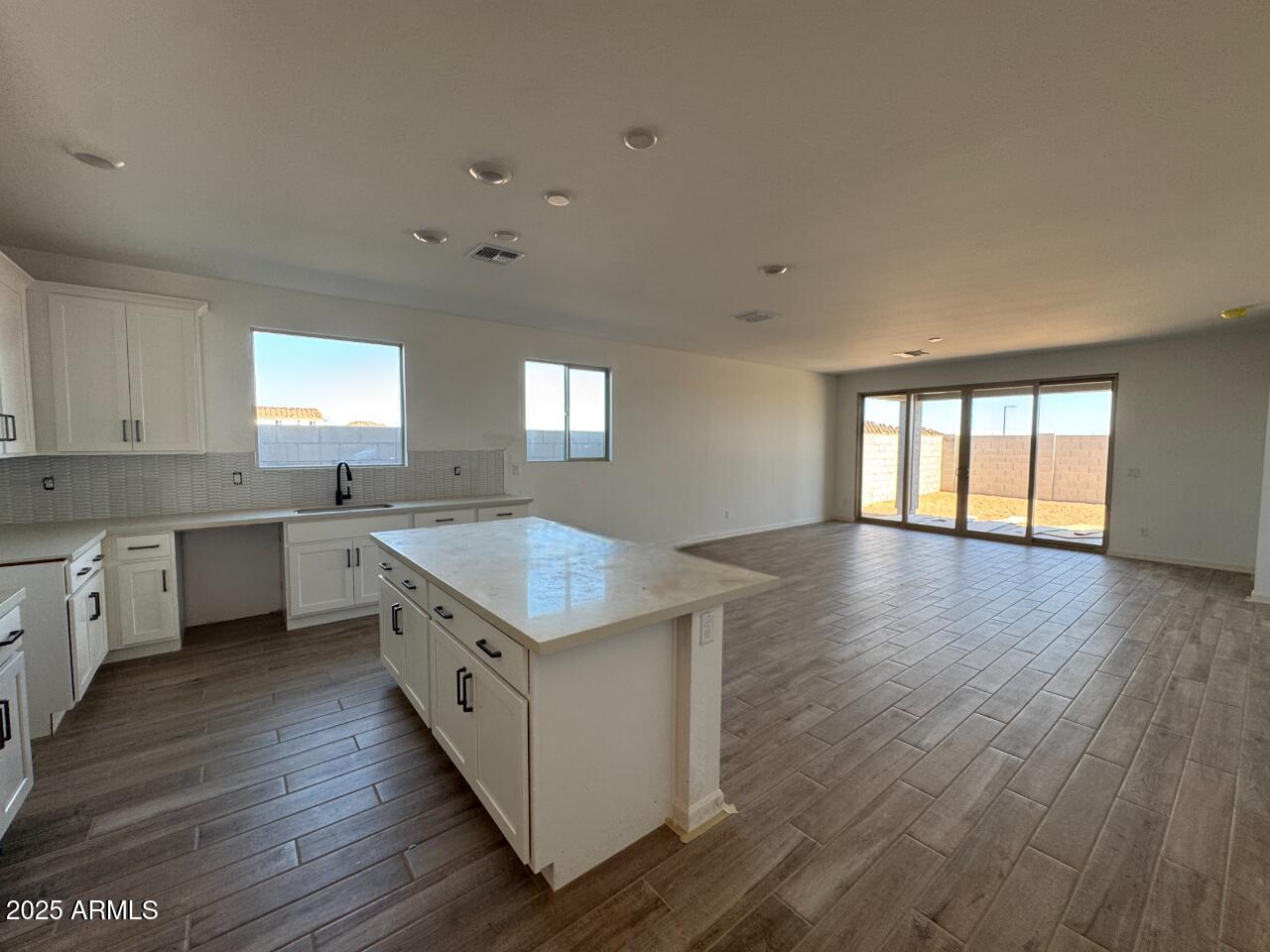 16181 West Bajada Road Surprise, AZ 85387 - Photo 6 of 21 a kitchen with wooden floors and white walls