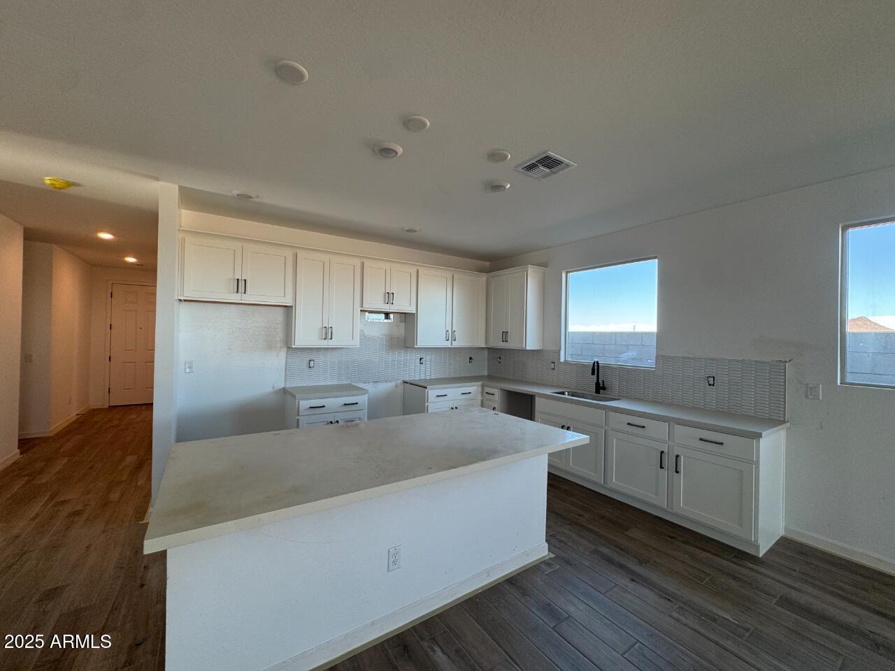 16181 West Bajada Road Surprise, AZ 85387 - Photo 7 of 21 a large kitchen with a lot of counter space and wooden floor