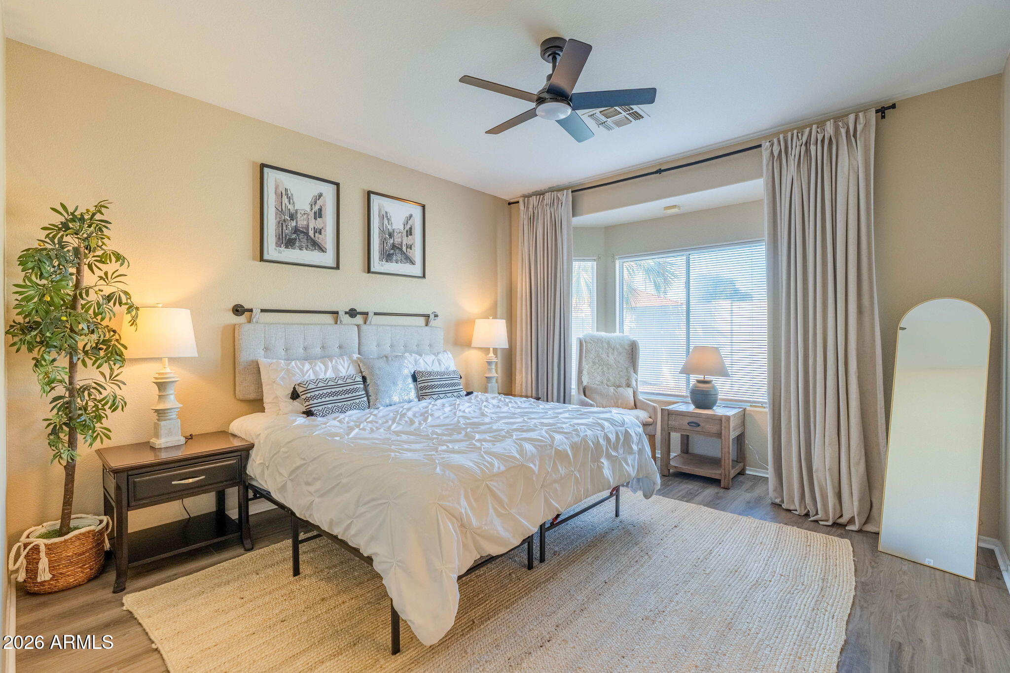 3674 South Joshua Tree Lane Gilbert, AZ 85297 - Photo 18 of 30 a bedroom with a bed and a chandelier