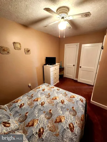 a bedroom with a bed and a mirror