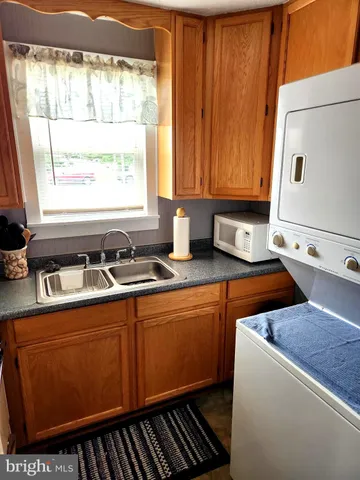 a kitchen with stainless steel appliances a sink stove and window