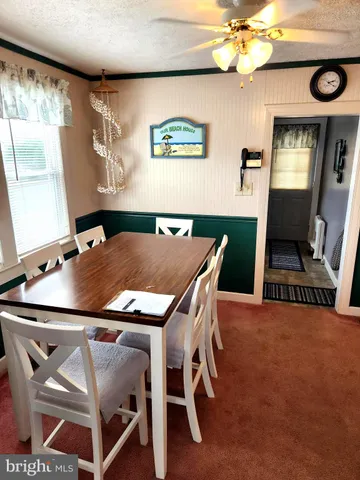 a view of a dining room with furniture and a chandelier