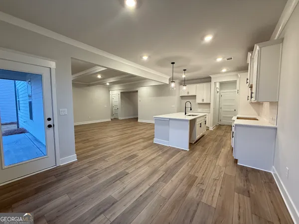an empty room with windows and ceiling fan