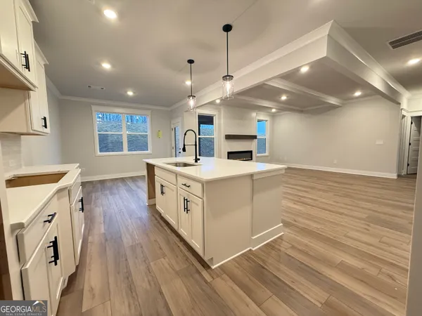a view of a room with wooden floor