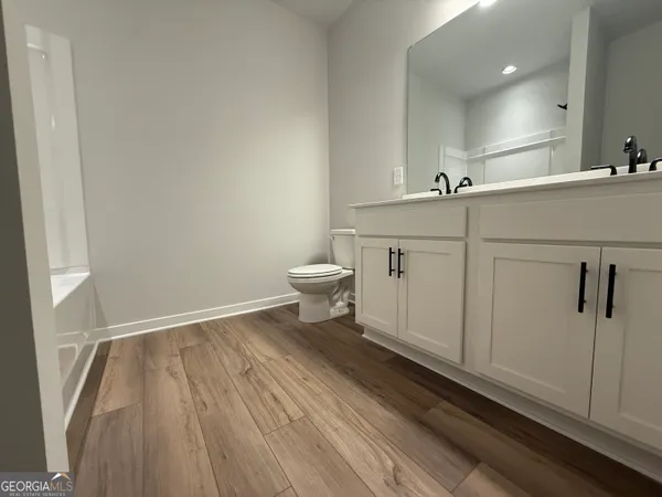 a view of a yard with plants and trees