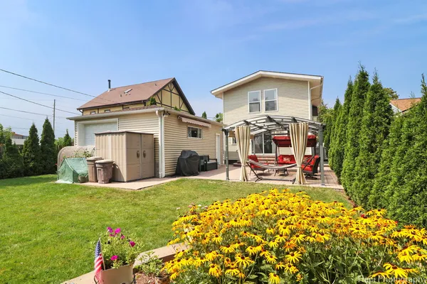 a view of a house with table and chairs in front of house