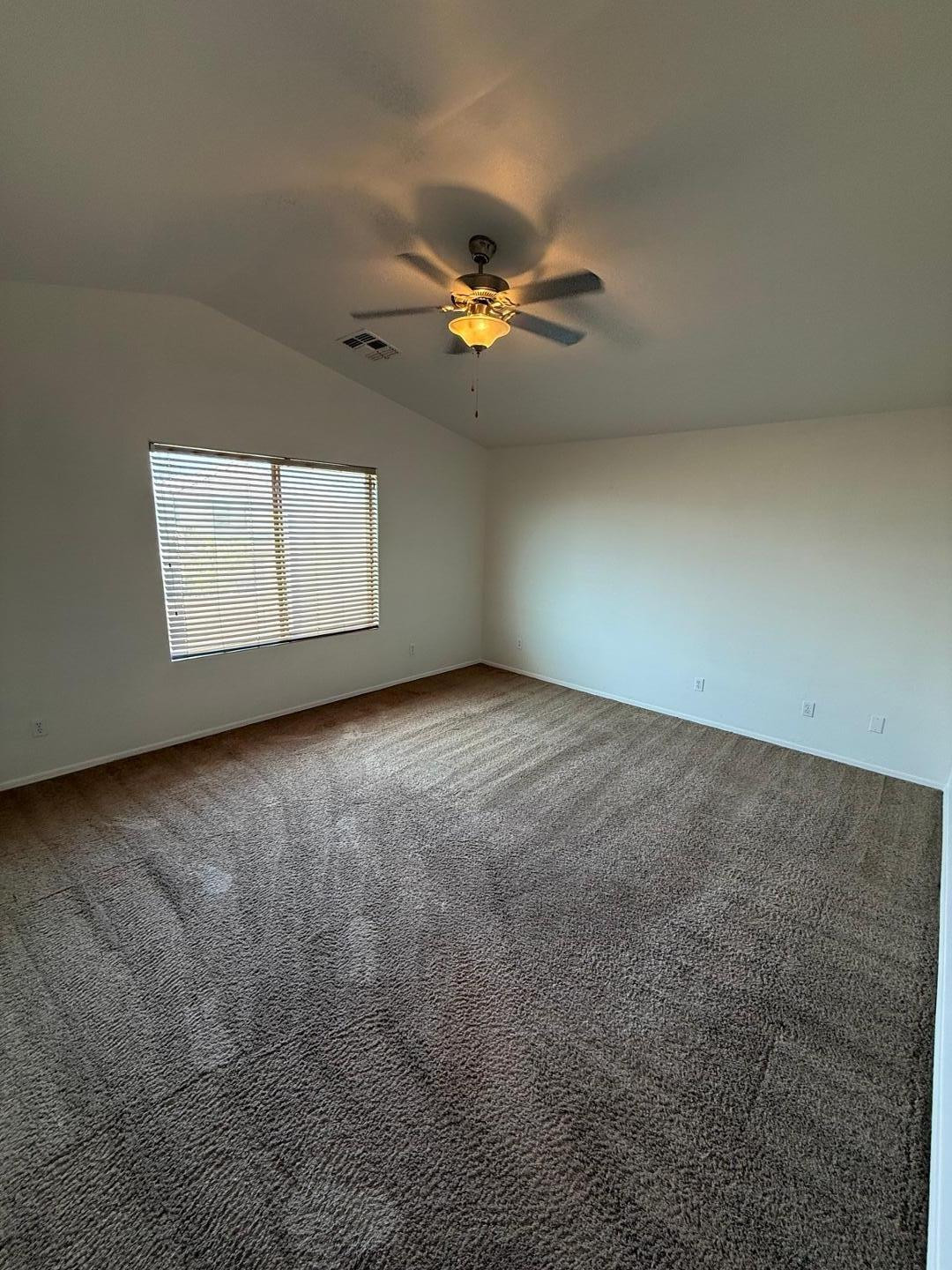 4319 West Darrel Road Laveen, AZ 85339 - Photo 13 of 16 an empty room with windows and fan