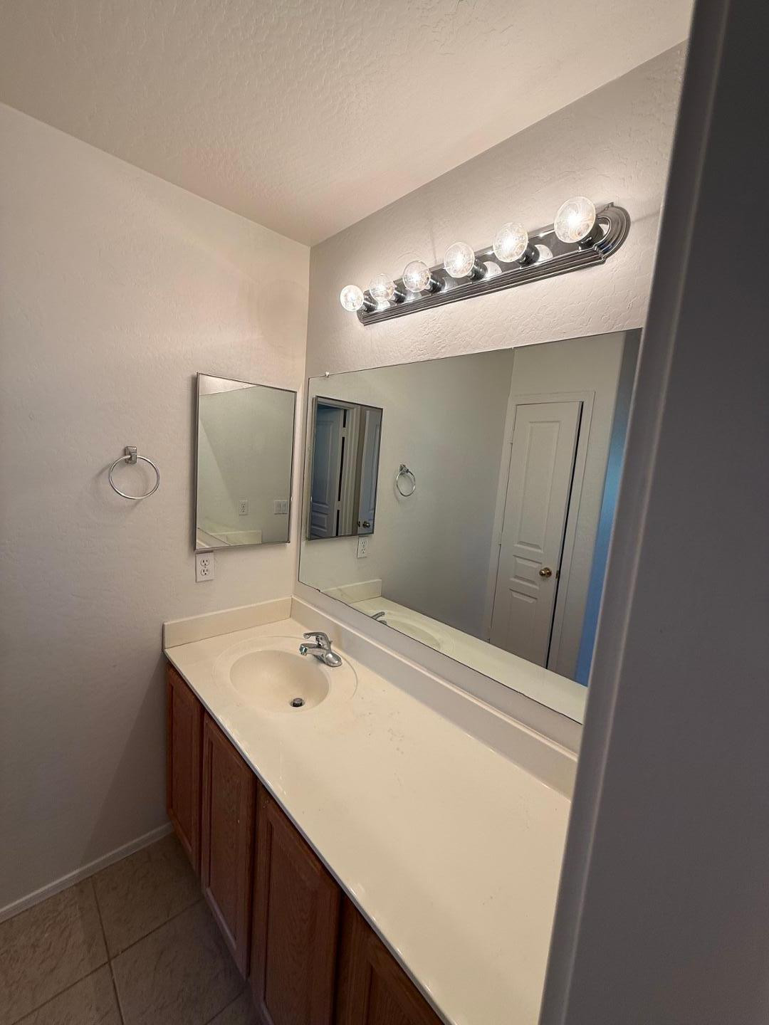 4319 West Darrel Road Laveen, AZ 85339 - Photo 14 of 16 a bathroom with a sink and a mirror