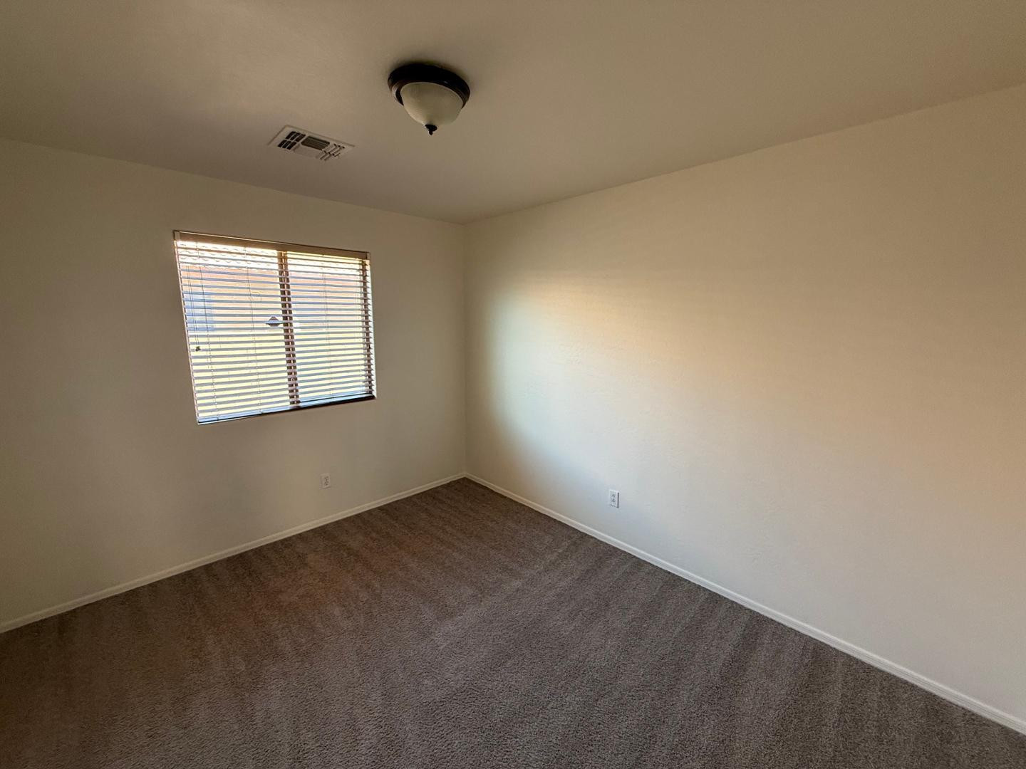 4319 West Darrel Road Laveen, AZ 85339 - Photo 6 of 16 an empty room with windows