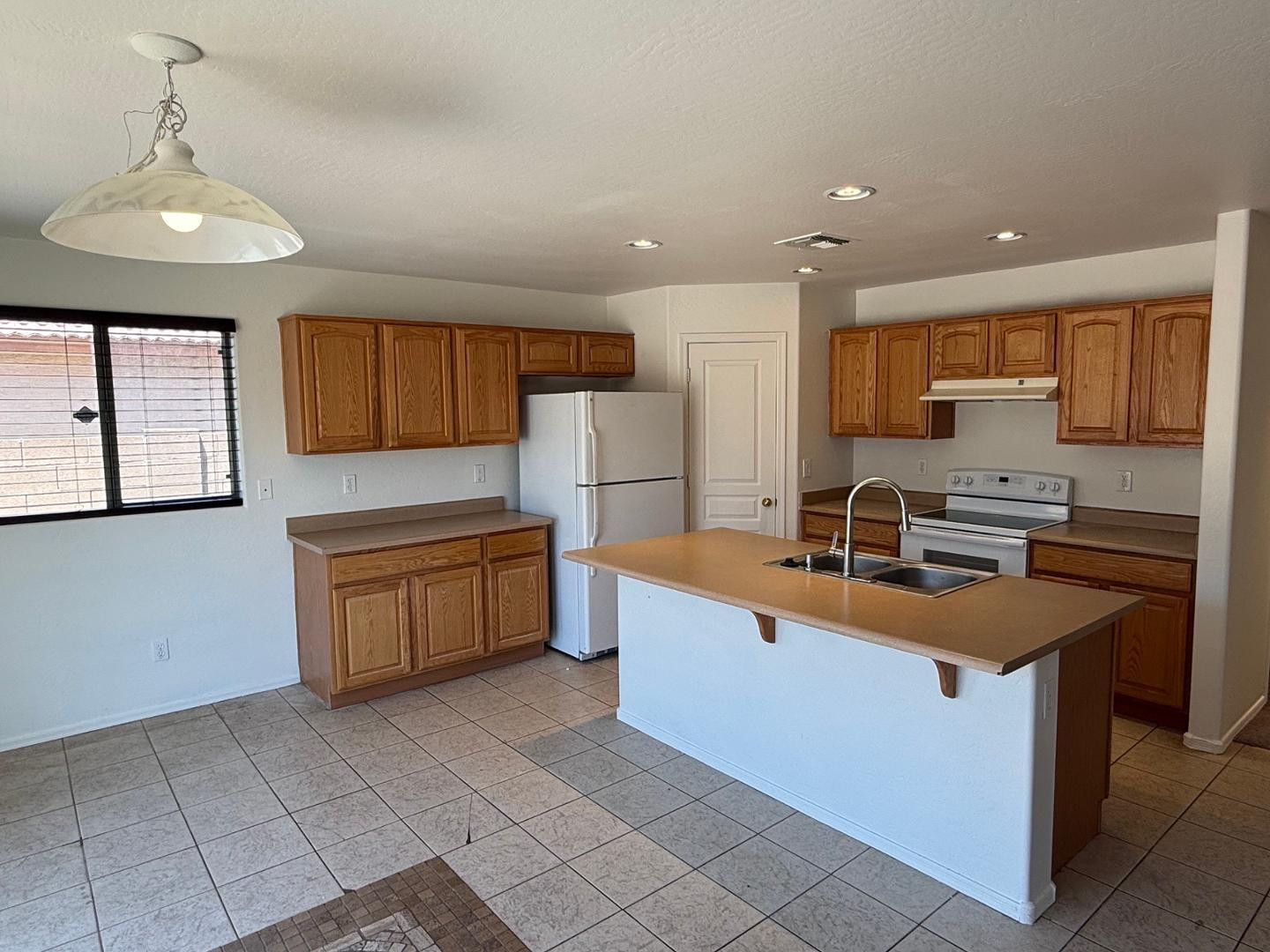 4319 West Darrel Road Laveen, AZ 85339 - Photo 8 of 16 a kitchen with stainless steel appliances granite countertop a sink stove and refrigerator