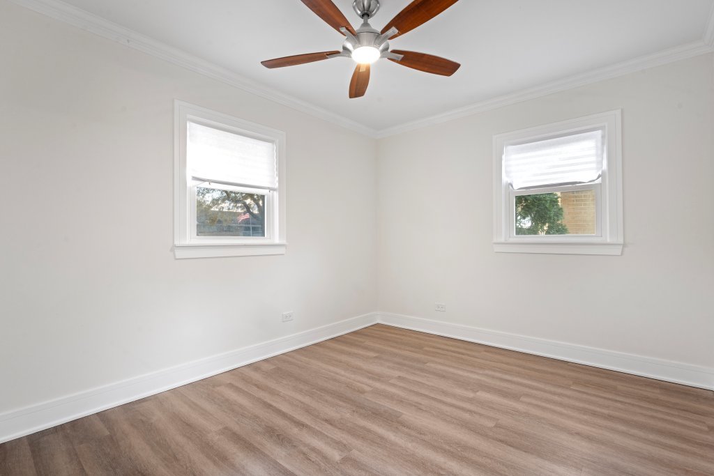 8330 45th Street Lyons, IL 60534 - Photo 19 of 26 a view of empty room with wooden floor and fan