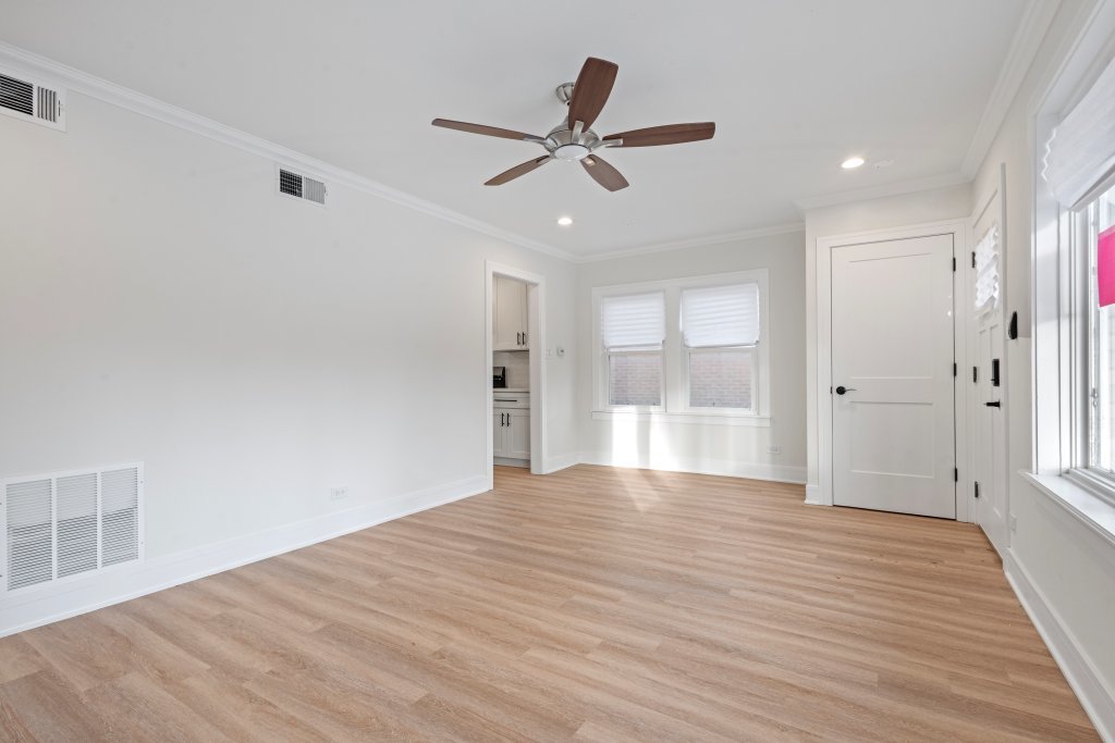 8330 45th Street Lyons, IL 60534 - Photo 21 of 26 a view of an empty room with wooden floor and a window