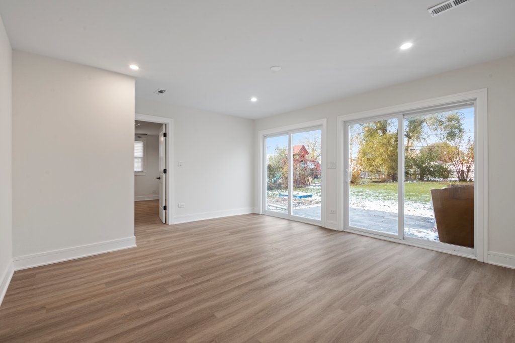 8330 45th Street Lyons, IL 60534 - Photo 4 of 26 a view of an empty room with wooden floor and a window