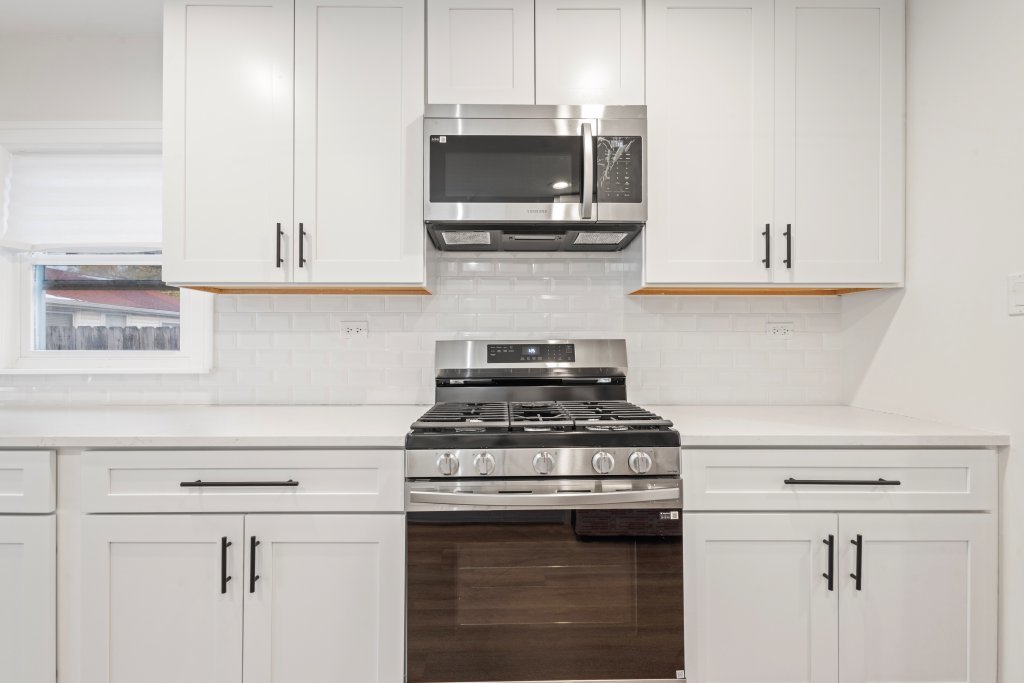 8330 45th Street Lyons, IL 60534 - Photo 6 of 26 a kitchen with stainless steel appliances granite countertop a stove and a microwave