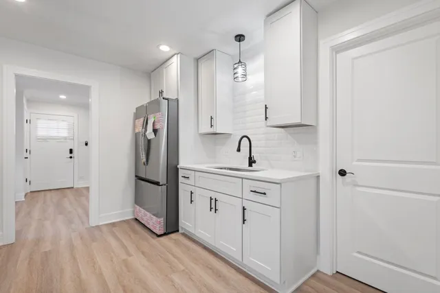 a kitchen with stainless steel appliances a refrigerator sink and cabinets