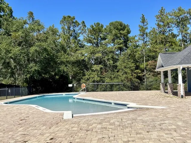 a view of a swimming pool with a yard