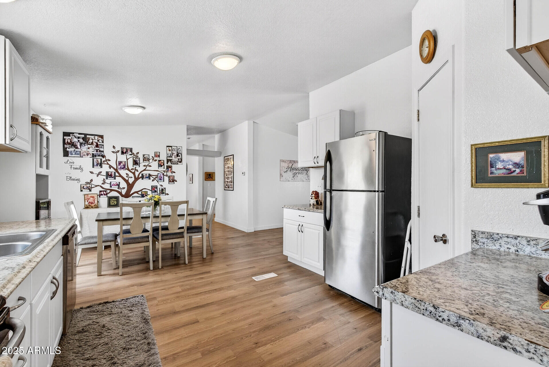 16101 North El Mirage Road, Unit 353 El Mirage, AZ 85335 - Photo 11 of 46 a kitchen with granite countertop a refrigerator a stove a dining table and chairs