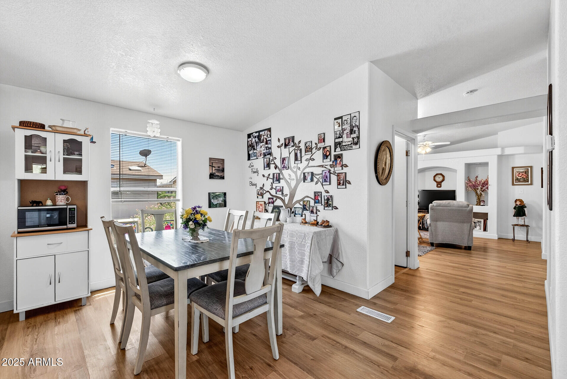 16101 North El Mirage Road, Unit 353 El Mirage, AZ 85335 - Photo 13 of 46 a view of a dining room with furniture and wooden floor