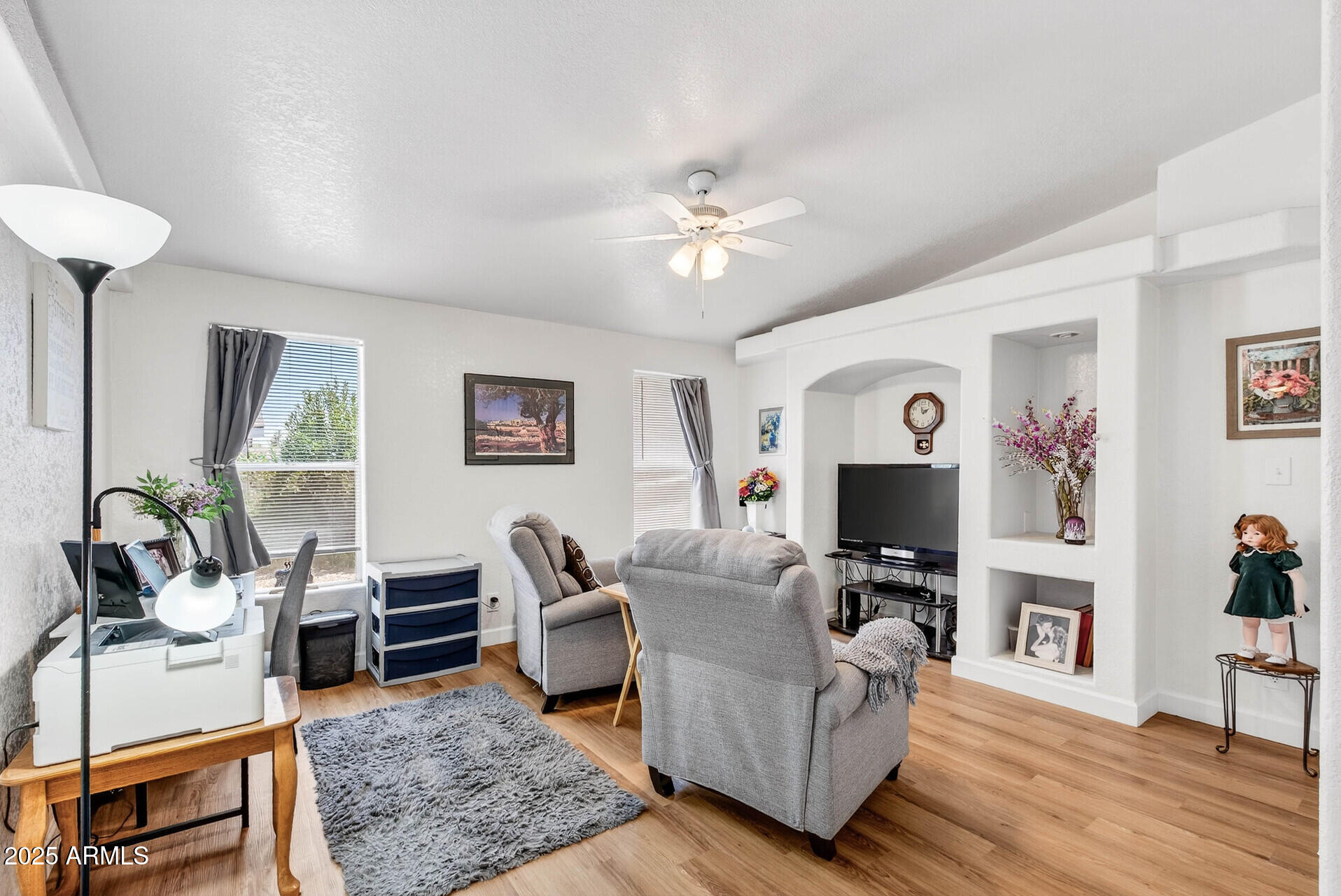 16101 North El Mirage Road, Unit 353 El Mirage, AZ 85335 - Photo 14 of 46 a living room with furniture a fireplace and a flat screen tv