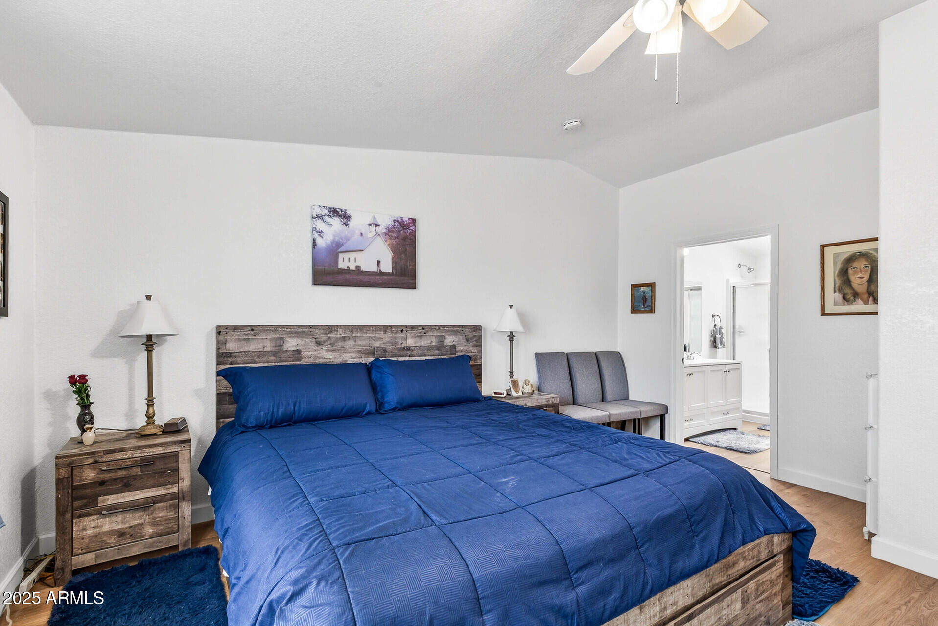 16101 North El Mirage Road, Unit 353 El Mirage, AZ 85335 - Photo 19 of 46 a bedroom with a large bed and a chandelier