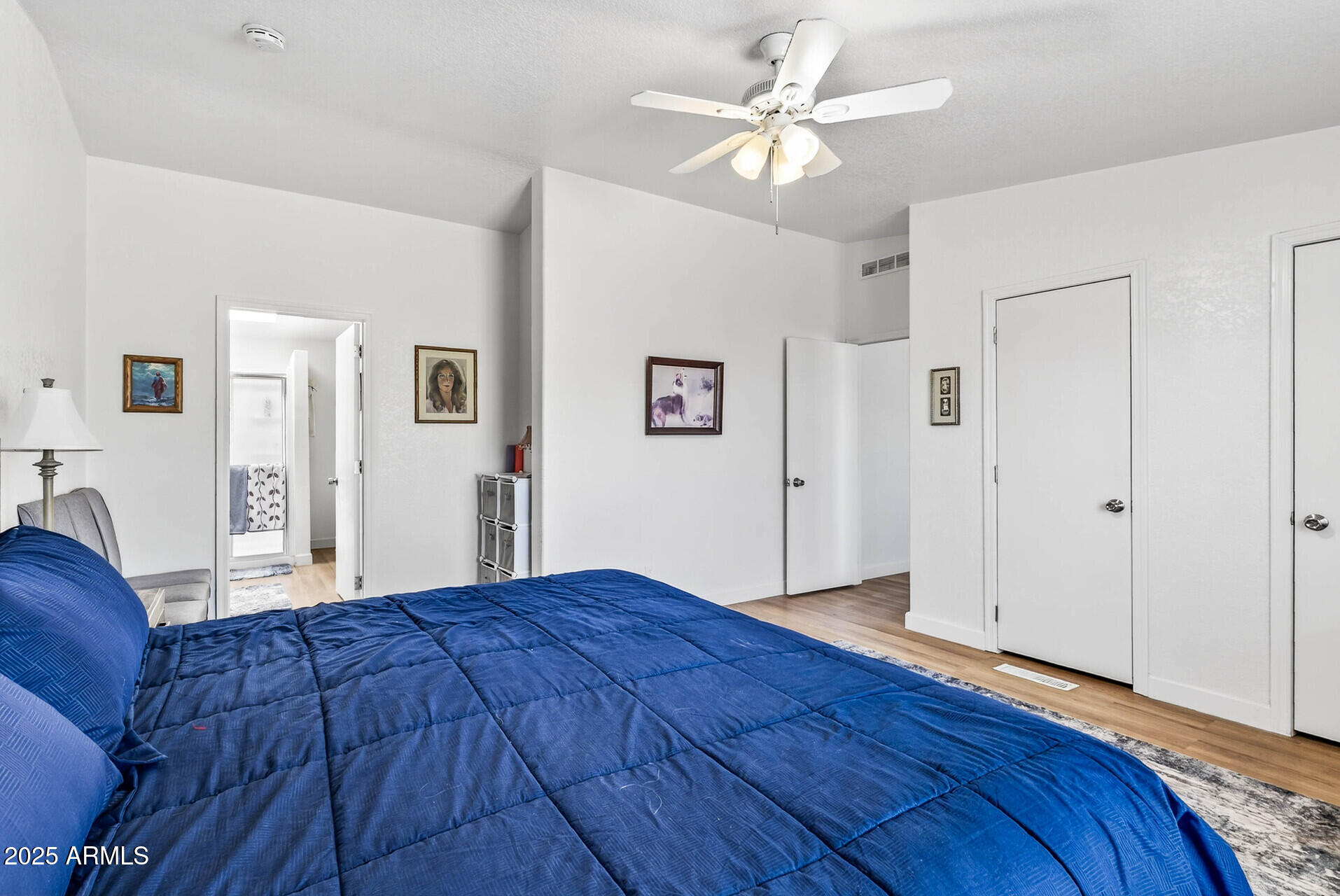 16101 North El Mirage Road, Unit 353 El Mirage, AZ 85335 - Photo 20 of 46 a bedroom with a large bed closet and a window