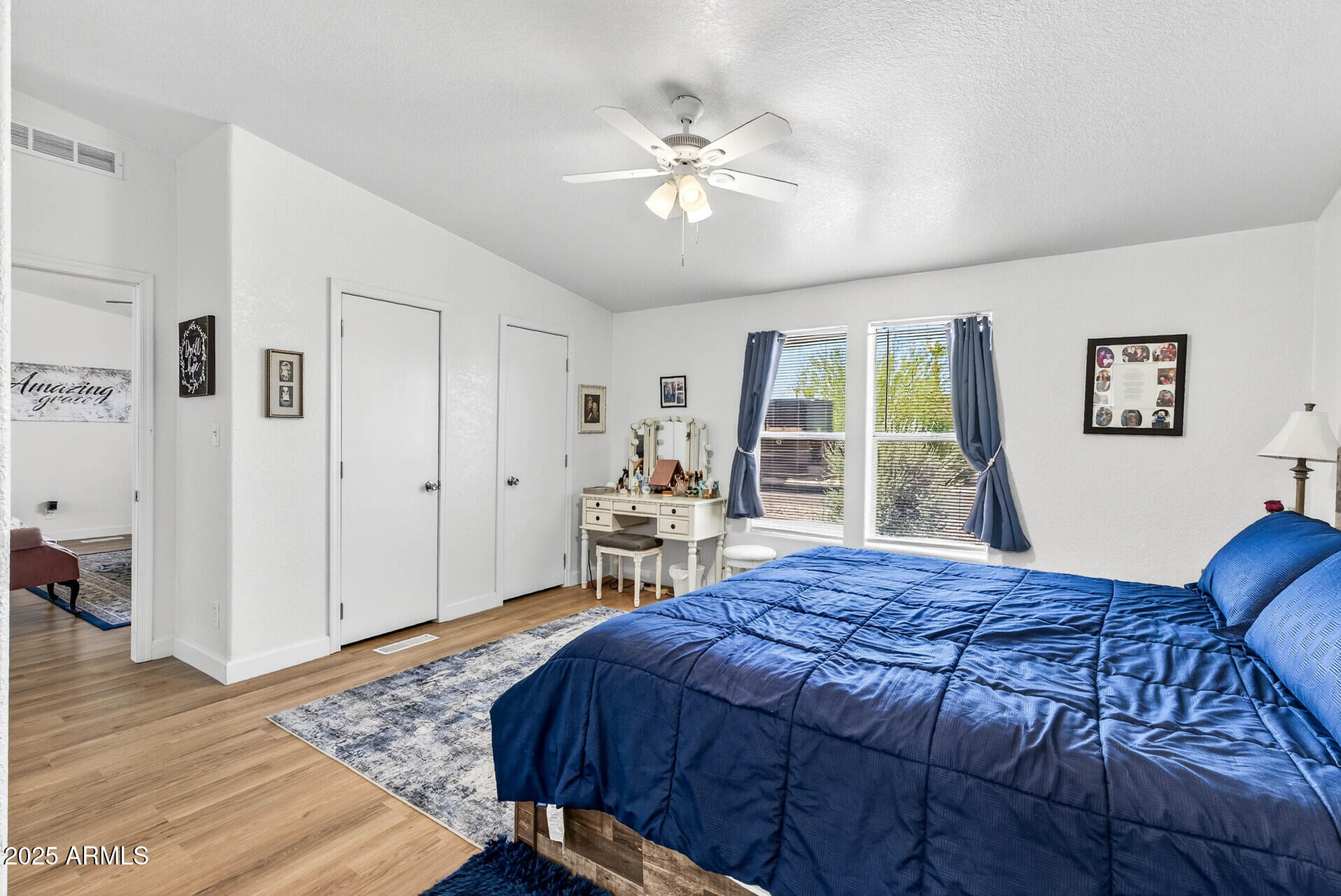 16101 North El Mirage Road, Unit 353 El Mirage, AZ 85335 - Photo 21 of 46 a bed sitting in a spacious bedroom next to a window