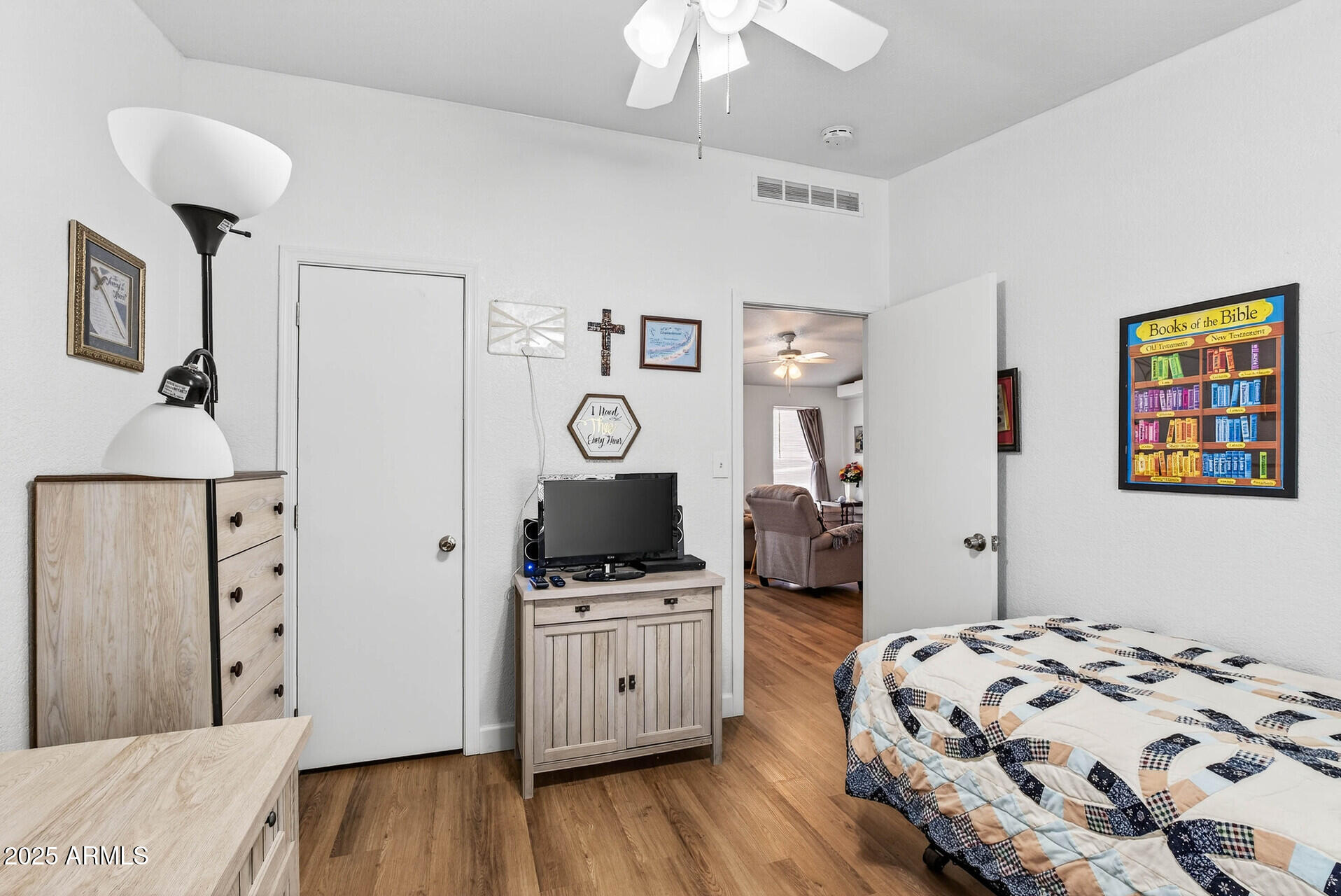 16101 North El Mirage Road, Unit 353 El Mirage, AZ 85335 - Photo 25 of 46 a bedroom with a bed and a flat tv screen on the dresser