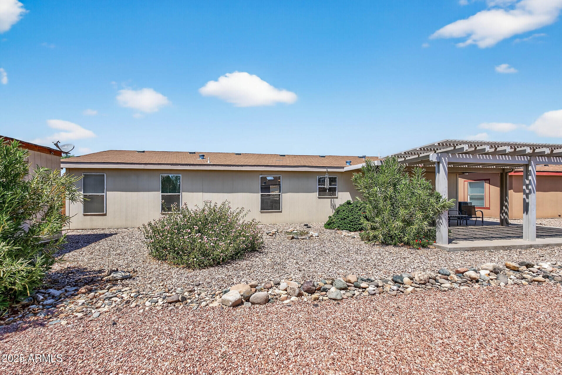 16101 North El Mirage Road, Unit 353 El Mirage, AZ 85335 - Photo 33 of 46 a view of a house with a backyard and sitting area