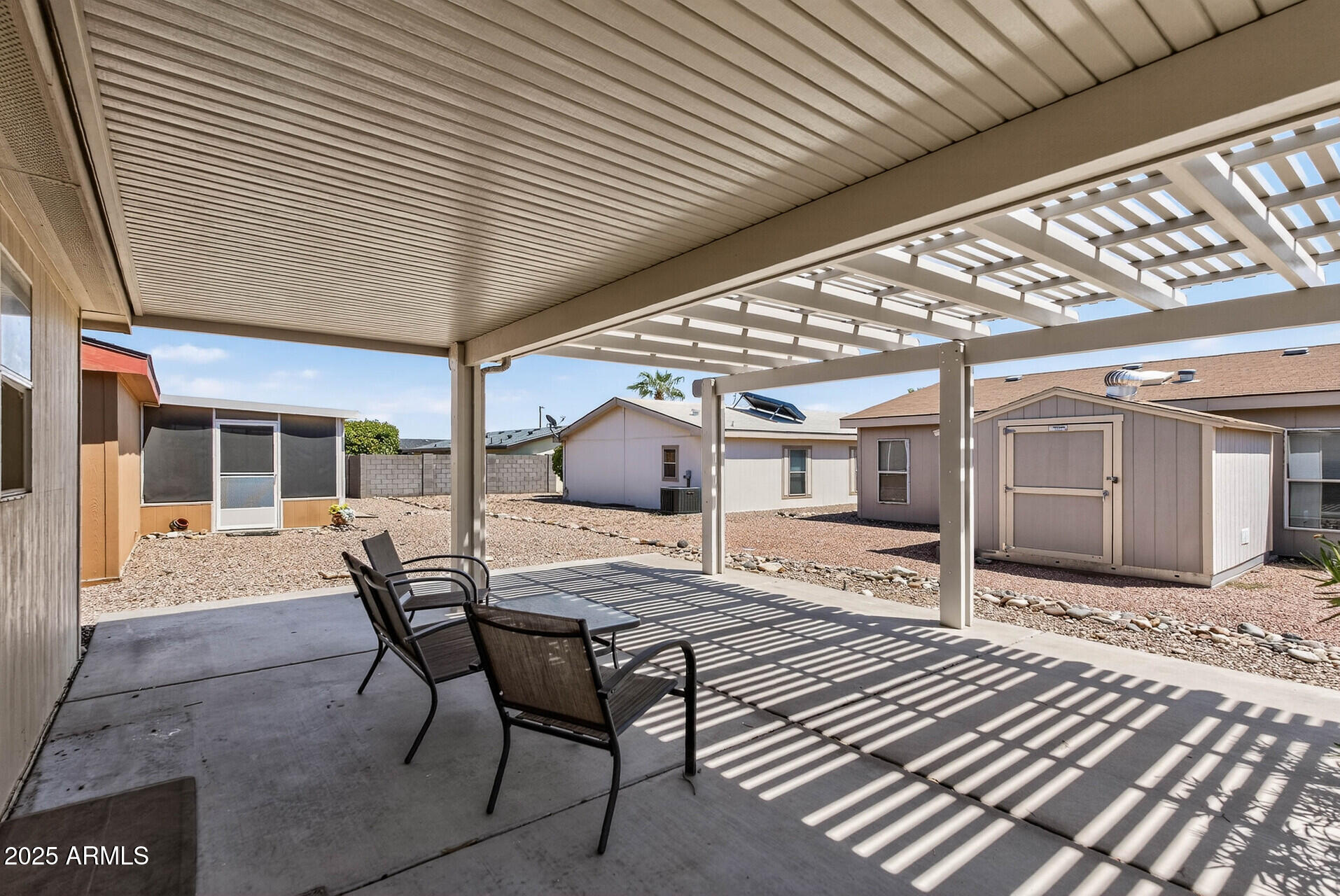 16101 North El Mirage Road, Unit 353 El Mirage, AZ 85335 - Photo 37 of 46 a view of a patio with table and chairs and wooden floor
