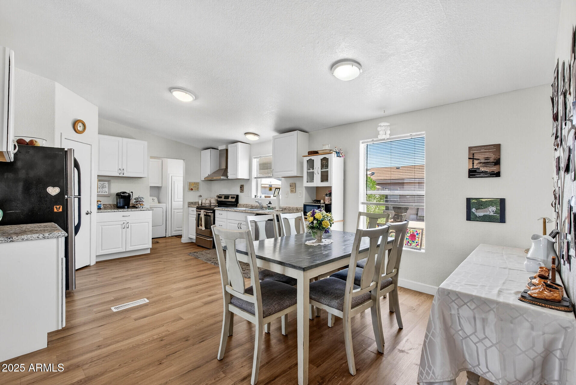 16101 North El Mirage Road, Unit 353 El Mirage, AZ 85335 - Photo 41 of 46 a view of a dining room with furniture and wooden floor