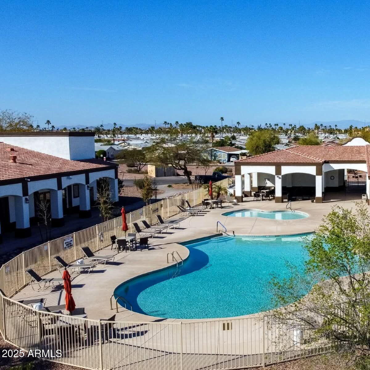 16101 North El Mirage Road, Unit 353 El Mirage, AZ 85335 - Photo 42 of 46 a swimming pool with outdoor seating and yard