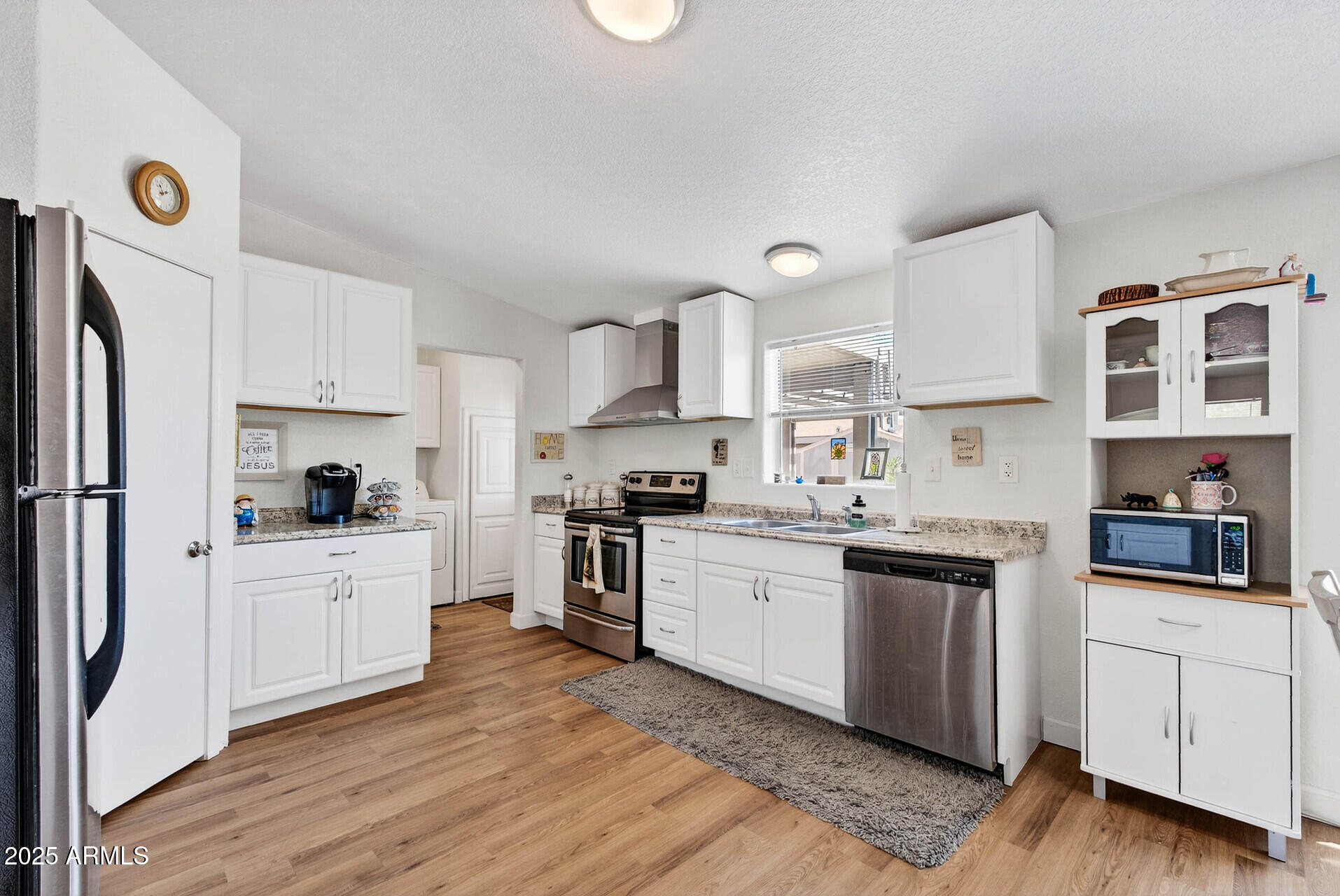 16101 North El Mirage Road, Unit 353 El Mirage, AZ 85335 - Photo 10 of 46 a kitchen with kitchen island granite countertop a sink cabinets and stainless steel appliances