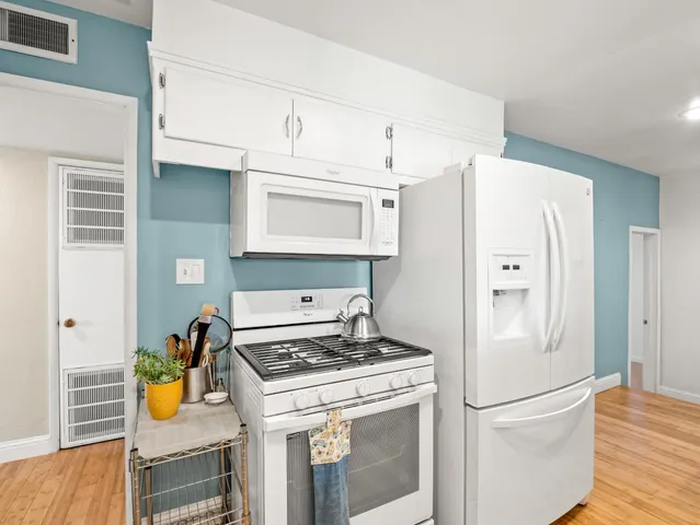 a kitchen with stainless steel appliances a refrigerator a stove and a sink
